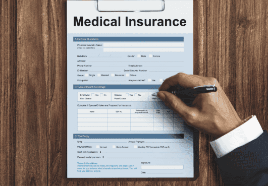 Person filling out medical insurance claim form.
